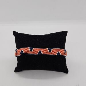 Juicy Couture light orange and blue threaded bracelet with bells